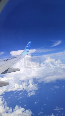 Photo for Airplane wing in cloudy sky - Royalty Free Image