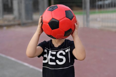 Photo for Faceless portrait of little boy with soccer ball. - Royalty Free Image