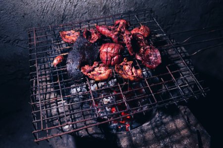 Photo for The offal is grilled on a grill over a hot fire. - Royalty Free Image