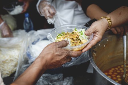 Photo for Giving free food to the poor in the community: the idea of helping without expectation of return. - Royalty Free Image