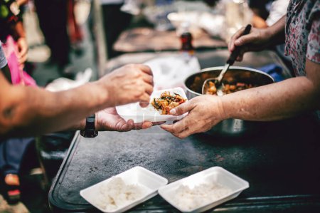 Photo for From hand to hand : Sharing Food With Homeless - Royalty Free Image