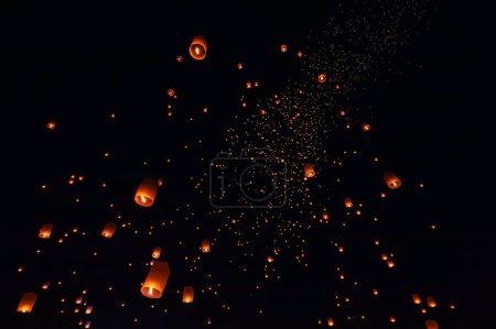 The beauty of the lanterns floating in the sky during the Yi Peng Festival and the Floating Lantern Festival in Chiang Mai Province, Thailand.