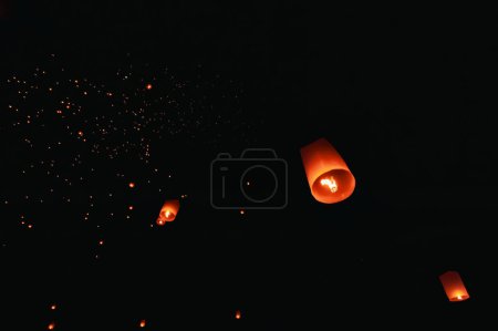 The beauty of the lanterns floating in the sky during the Yi Peng Festival and the Floating Lantern Festival in Chiang Mai Province, Thailand.