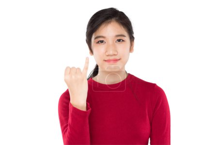 asiático adolescente mostrar meñique dedo, expresando un deseo de reconciliar