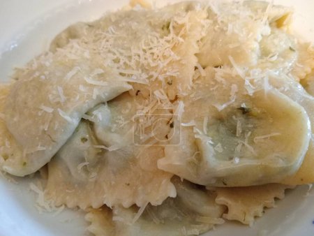 Photo for Typical Emilian dish, tortelli stuffed with herbs, butter and grated cheese. Italian food - Royalty Free Image