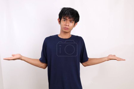 Photo for Asian young man standing with nescience expression and gesture. Isolated on white background - Royalty Free Image