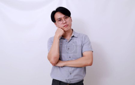 Photo for Sad asian man standing while doing nothing. Daydreaming concept - Royalty Free Image