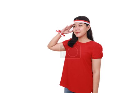 Photo for Young Indonesian girl celebrate indonesia independence day with respect gesture - Royalty Free Image