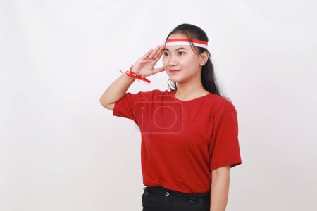 Photo for Young Indonesian girl celebrate indonesia independence day with respect gesture - Royalty Free Image