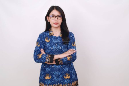 Photo for Asian female in batik korpri, indonesian traditional uniform standing with folded hands - Royalty Free Image