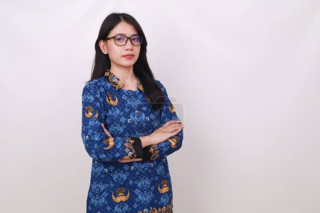 Photo for Asian female in batik korpri, indonesian traditional uniform standing with folded hands - Royalty Free Image
