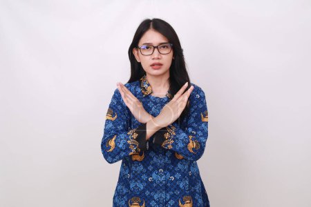 Photo for Asian female in batik korpri, indonesian traditional uniform crossing her hands - Royalty Free Image