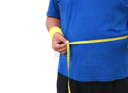 Photo for Close up photo of overweight man in sportswear measuring his belly with measuring tape. Isolated - Royalty Free Image