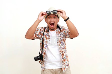 Photo for Surprised asian adult man tourist standing with unbelievable face expression. Concept of travel. Isolated on white background - Royalty Free Image