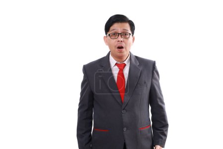 Photo for Shocked asian businessman standing with open mouth while looking at the camera. ISolated on white - Royalty Free Image