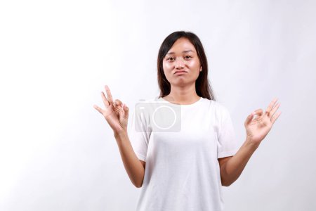 Young asian woman doing excellent gesture with hand depressed and worry for distress, crying angry and afraid. sad expression.