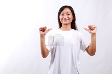 Confident asian girl showing pointing herself and making happy facial expression isolated on white background