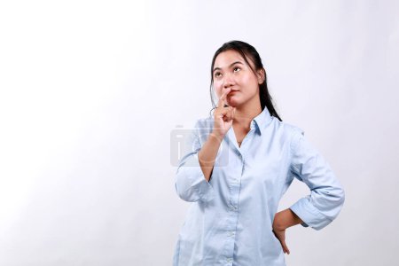Young minded happy woman of Asian ethnicity 20s wear office clothes look above on workspace area mock up prop up chin isolated on white background studio People lifestyle concept