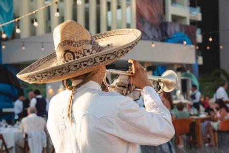 Photo for Close up of Mexican Mariachi,  traditional musical ensemble generally made up of a minimum number of three members; generally using guitar, guitar, violin and trumpets - Royalty Free Image