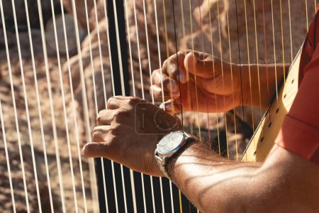 Photo for Close up of harp instrument being played - Royalty Free Image