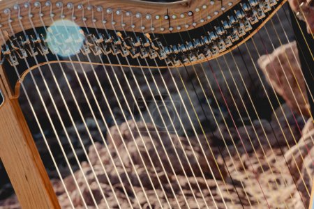 Photo for Close up of harp instrument being played - Royalty Free Image