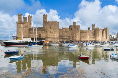 Photo for Caernarfon Castle on the River Seiont overlooking the Menai Strait in North Wales - Royalty Free Image