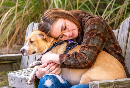 A young girl with epilepsy hugs her seizure alert dog, a very special companion