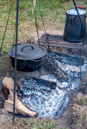 using cast iron to cook over a open fire at a camp site