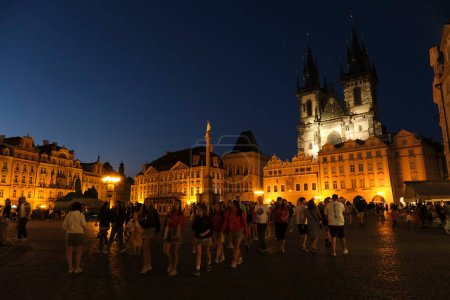 Crowd of tourists walking in famous Old Town Square in Prague, Czech Republic on July 27, 2022.