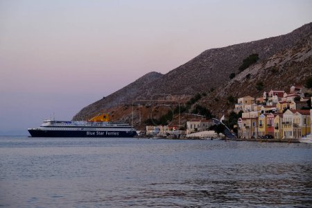 Photo for A boat leaves the harbor of Symi , Greece on August 3, 2022. - Royalty Free Image