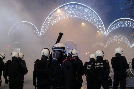Photo for Protestors clashed with riot police after the Qatar 2022 World Cup football match between Belgium and Morocco, in Brussels, Belgium on November 27, 2022. - Royalty Free Image