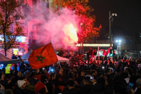 Photo for Moroccan supporters celebrating their victory in the center of Brussels, after winning the quarter final game between Morocco and Portugal, at the FIFA 2022 World Cup. Belgium, December 10, 2022. - Royalty Free Image