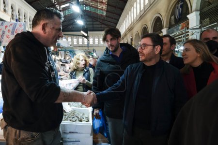 Photo for President of the Movement for Change and the Panhellenic Socialist Movement Nikos Androulakis visits the Varvakeio flea market in Athens, Greece on December 29, 2022. - Royalty Free Image