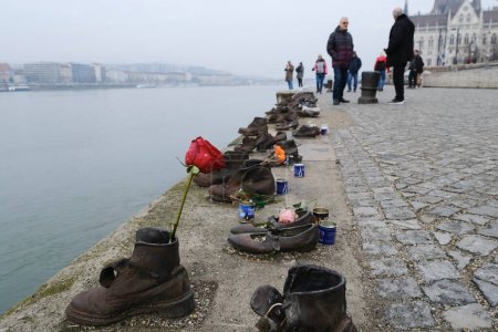 Foto de The memorial of shoes remembering the Holocaust victims on the bank of the River Danube in downtown Budapest, Hungary on December 22, 2022. - Imagen libre de derechos