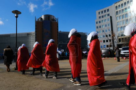 Photo for Demonstrators dressed as handmaidens from The Handmaid's Tale protest against Israeli Prime Minister Benjamin Netanyahu in Brussels, Belgium on March 27, 2023. - Royalty Free Image