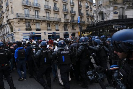 Photo for Riot police clashed with protestors during a demonstration in a national strike against government plans to revamp the pension system in central Paris, France on April 06, 2023. - Royalty Free Image