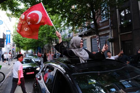 Photo for Supporters of Turkish President Erdogan celebrate after the results of the runoff election in Brussels, Belgium on May 28, 2023. - Royalty Free Image