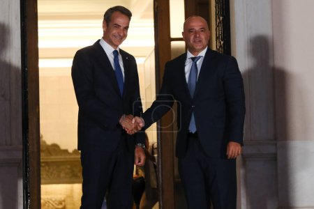 Photo for Greece's Prime Minister Kyriakos Mitsotakis, left, welcomes Prime Minister of North Macedonia Dimitar Kovacevski before an informal dinner at Maximou mansion in Athens, Greece on Aug. 21, 2023. - Royalty Free Image