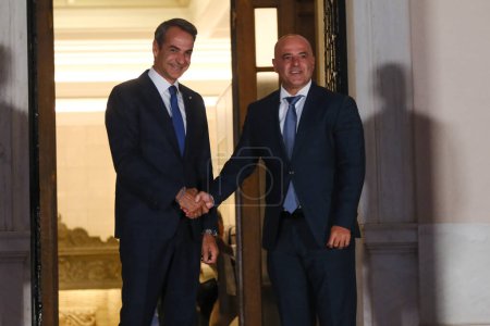 Photo for Greece's Prime Minister Kyriakos Mitsotakis, left, welcomes Prime Minister of North Macedonia Dimitar Kovacevski before an informal dinner at Maximou mansion in Athens, Greece on Aug. 21, 2023. - Royalty Free Image