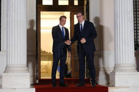 Photo for Greece's Prime Minister Kyriakos Mitsotakis, left, welcomes Aleksandar Vucic, President of Serbia before an informal dinner at Maximou mansion in Athens, Greece on Aug. 21, 2023. - Royalty Free Image