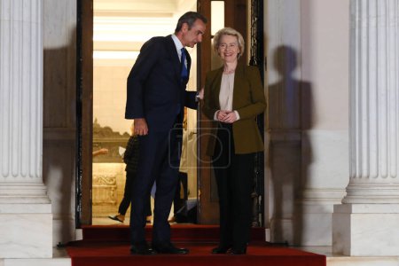 Photo for Greece's Prime Minister Kyriakos Mitsotakis, left, welcomes European Commission President Ursula von der Leyen Before an informal dinner at Maximou mansion in Athens, Greece on Aug. 21, 2023. - Royalty Free Image