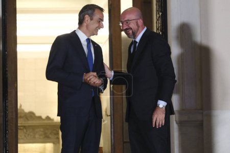 Photo for Greece's Prime Minister Kyriakos Mitsotakis, left, welcomes European Council President Charles Michel before an informal dinner at Maximou mansion  in Athens, Greece on Aug. 21, 2023. - Royalty Free Image