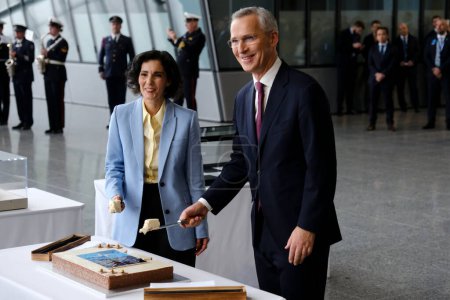 Photo for NATO Secretary General Jens Stoltenberg and Foreign Minister Hadja Lahbib cut a cake during a ceremony to mark the 75th anniversary of NATO at NATO headquarters in Brussels, Belgium on April 4, 2024. - Royalty Free Image