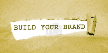 Photo for BUILD YOUR BRAND message written under torn paper. Branding rebranding marketing business concept. - Royalty Free Image