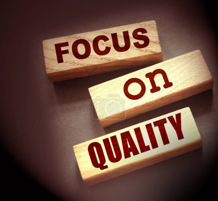 Focus on Quality words of on wooden blocks. Honesty in business concept.