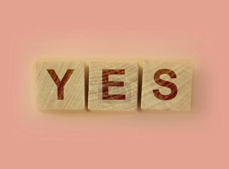 Photo for Wooden cubes with word YES on pink table. Positive answer and positive thinking concept. - Royalty Free Image
