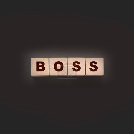 The boss sign on a wooden cubes on black. Business owner concept.