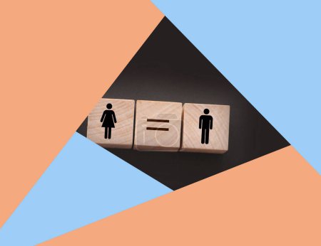 Foto de Conceptos de igualdad de género. cubos de madera con símbolo femenino y masculino y signo igual. Igualdad de retribución concepto de cuarentena social. - Imagen libre de derechos