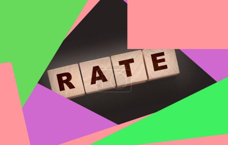 Photo for Rate word concept written on wooden cubes blocks lying on a black background. Business services rating concept. - Royalty Free Image