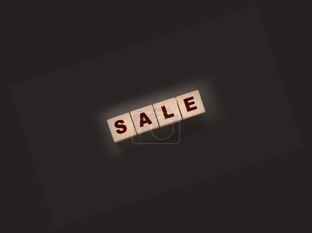 Photo for The word sale on wooden cubes on a black background. Business concept - Royalty Free Image